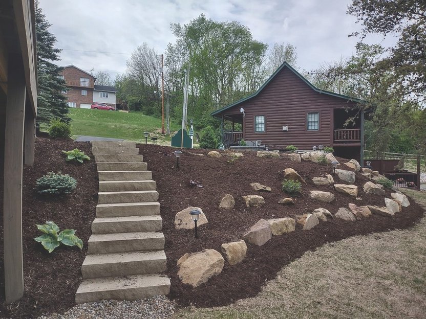 Stone fireplace under timber frame pavilion in Northeast Ohio